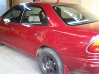 Red Mazda 323 1999 at 100000 km for sale