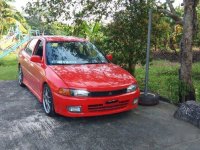 Selling Red Mitsubishi Lancer 1997 Manual Gasoline 