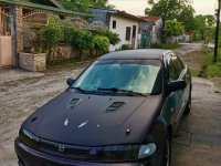 Black Mazda Protege for sale in Dau