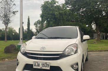 Pearl White Toyota Wigo 2014 for sale in Quezon City